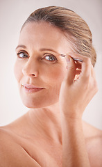 Image showing Eyebrows, tweezers and portrait of a mature model on white background for facial grooming or hair removal. Beauty, salon and face of female person isolated in studio plucking or tweezing for skincare