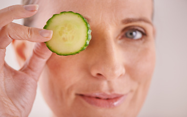 Image showing Beauty, cucumber and portrait of woman in studio for health, wellness or natural facial routine. Smile, skincare and mature person with organic vegetable for dermatology treatment by white background