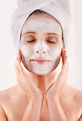 Image showing Face, mask or woman in studio for facial or skincare routine with natural detox or cosmetics with towel. Model, spa or female person with lotion for anti aging treatment or beauty on white background