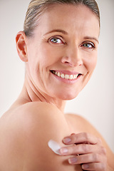 Image showing Model, smile and studio with skincare, lotion and portrait with treatment. Mature woman, beauty and luxury with body, cosmetics and care for anti ageing and healthy skin for wellness and confidence