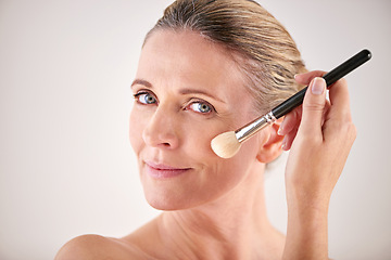 Image showing Brush, cosmetics and portrait of woman in studio for makeup, self care and facial flow routine. Beauty, foundation and female person with cosmetology tool for face treatment by gray background.