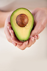 Image showing Hands, avocado and vegetable diet for antioxidants, nutrition and minerals or vitamins for health. Closeup, person and holding vegan food for green detox, superfoods and holding for organic skincare