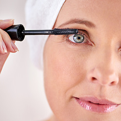 Image showing Makeup, mascara or portrait of woman with brush in studio for beauty, cosmetics or application. Eyelash, white background or face of mature model with product or tool for volume, glamour or aesthetic