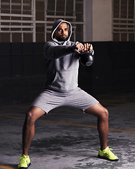 Image showing Man, fitness and workout with kettlebell for training, muscle exercise and endurance in parking lot. Bodybuilder, serious face and equipment with weight for balance, strength and healthy body