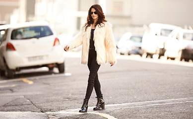 Image showing Woman, fashion and walk in city on with confidence in winter or cold weather with street wear and downtown New York. Female person, style and trendy clothes or outfit and sunglasses for trends