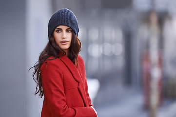 Image showing Winter, fashion and woman with jacket in city for travel and walking commute in cool style with red coat. Streetwear, clothes and outdoor on sidewalk with confidence and pride in New York morning