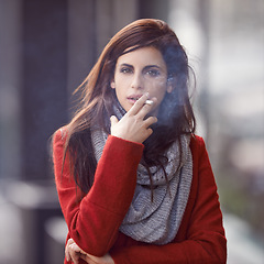 Image showing Portrait, winter and woman with a cigarette, city and cold weather with addiction in New York. Face, person and girl smoking, fashion and casual outfit with season and tobacco with style or bad habit