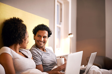 Image showing Apartment, laptop and couple with smile for working from home in bedroom, eye contact and together with love. Partners, woman and man on bed of house with technology for career and coffee in morning