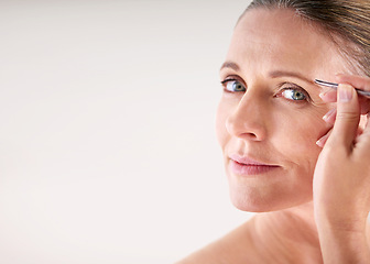 Image showing Mockup, tweezers or portrait of mature woman on white background for facial grooming or hair removal. Space, salon or face of female model in studio plucking or tweezing eyebrows for skincare beauty