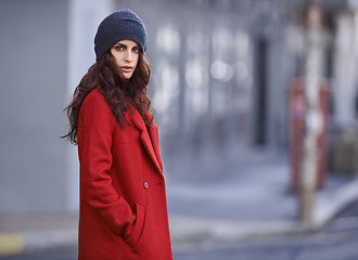 Image showing Winter, jacket and woman with fashion in city for travel and walking commute in cool style with red coat. Streetwear, clothes and outdoor on sidewalk with confidence and pride in New York morning