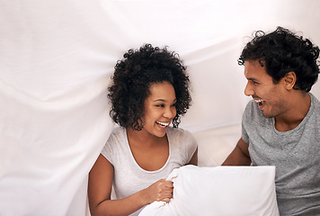Image showing Couple, bed and pillow playful with sheet for carefree weekend with partnership, happiness or bonding. Man, woman and linen in apartment for holiday vacation on morning comfort, peace or relaxing