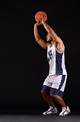 Image showing Man, shoot and basketball player in studio for game goals or workout competition, training or black background. Male person, playing and exercise performance or professional, fitness or mockup space