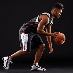 Image showing Man, basketball player and playing sport in studio for workout training, black background or mockup space. Male person, running and healthy performance for exercise wellness, practice or professional