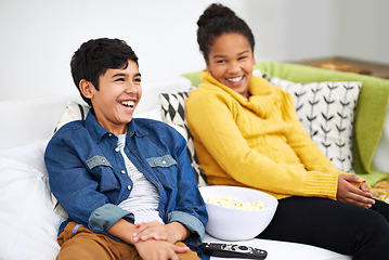 Image showing Happy family, siblings or popcorn for watching television, couch or laughing for funny joke on comedy show. Boy, girl or teenagers on sofa with cable network, relax or snack for subscription in home