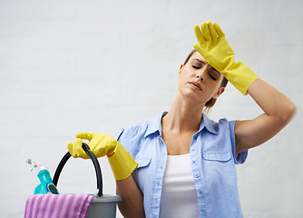 Image showing Woman, cleaning and tired for housekeeping in home, bleach and detergent for sanitation or disinfection. Female person, exhausted and maid for sterilization, supplies and rubber gloves for hygiene