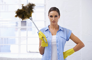 Image showing Feather, duster and portrait of woman cleaning in house, home or hotel with confidence. Housework, mission and serious girl, housekeeper or cleaner service for dirt, germs and sanitation in apartment