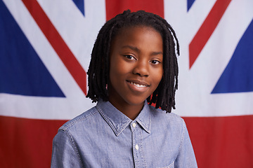 Image showing Kid, portrait and happy with UK flag or backdrop for citizenship, government and human rights. Smile and face of black child, student or boy from united kingdom and Union Jack background for support