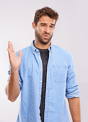 Image showing Disgust, man and waving his hands for smell, unpleasant and bad stink on a grey studio background. Face, person and model with gesture and body odor with fart and poor hygiene with negative aroma