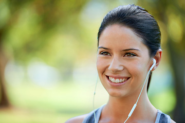 Image showing Woman, earphones and music for fitness in park, closeup and audio inspiration for training in marathon race. Young lady, happy or streaming radio for exercise, commitment or morning workout in nature