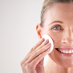 Image showing Senior woman, portrait or cotton for beauty in studio with facial cleansing, cosmetics or mockup space. Model, person or swab for face detox, makeup removal or anti aging skincare on white background