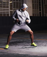 Image showing Man, kettlebell and muscle training for workout, strength exercise and healthy body in parking lot. Bodybuilder, equipment and challenge with weight for power, fitness and endurance development