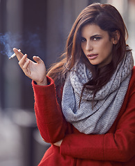 Image showing Portrait, winter and woman with a cigarette, outdoor and cold weather with a bad habit in New York city. Face, person and girl smoking, fashion and casual outfit with season and tobacco with style