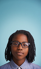 Image showing Vision, glasses or black kid portrait in studio for eye care, wellness or optometry on blue background. Frame, mockup or face of teen male model with eyesight, prescription or ophthalmology testing