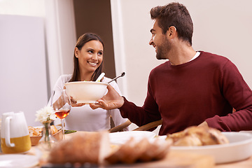 Image showing Smile, dinner and couple at table sharing food, and drinks for celebration in home. Social event, happy man and woman at thanksgiving lunch together with high angle, relax and romantic holiday date