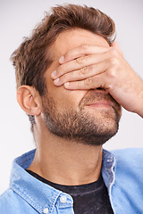 Image showing Man, face palm and mistake with thinking, regret or anxiety on a grey studio background. Person, fail or model with stress or memory with embarrassing with shame or bad decision with emoji or choice