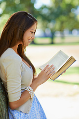 Image showing Happy woman, nature and reading book for learning, education or leisure in summer. Young person with story, fiction or literature for language, knowledge and studying or creative inspiration in park