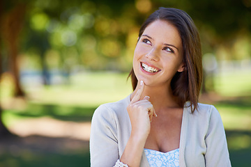 Image showing Thinking, sunshine and outdoor with woman, smile and ideas with decision and problem solving. Person, fresh air and girl in a park, happiness and choice with solution and options with weekend break