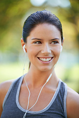 Image showing Woman, earphones and music for exercise in park, closeup and audio inspiration for training in marathon race. Young lady, happy or streaming radio for fitness, commitment or morning workout in nature