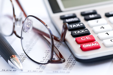 Image showing Tax calculator pen and glasses