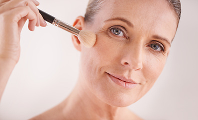 Image showing Makeup brush, face and portrait of woman in studio for cosmetic, self care and facial glow routine. Beauty, foundation and mature female person with cosmetology tool for treatment by white background