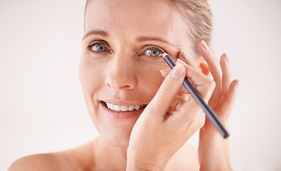 Image showing Makeup, portrait and woman with eyeliner in studio for beauty, natural and self care face routine. Cosmetics, smile and female person with cosmetology product for facial treatment by white background