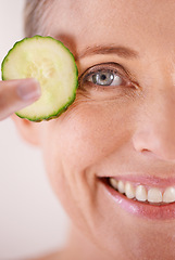 Image showing Skincare, cucumber and portrait of woman in studio for health, wellness or natural facial routine. Smile, beauty and mature person with organic vegetable for dermatology treatment by white background