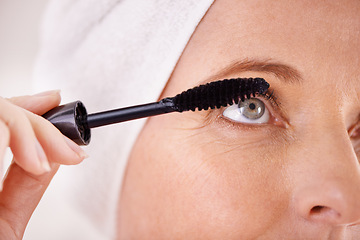 Image showing Makeup, mascara and closeup of woman with brush in studio for beauty, cosmetics or application. Eyelash, white background or face of female model with product or tool for volume, glamour or aesthetic