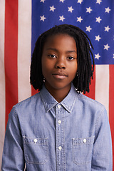 Image showing Children, portrait and black boy with American flag in studio for freedom, event or patriotic pride. Face, immigration and African kid with USA banner for Memorial Day, history or human rights banner