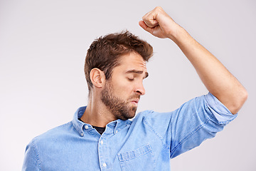 Image showing Man, smell armpit and sweat stain, bad hygiene or body odor with stink isolated on white background. Hyperhidrosis, poor hygiene and dirty, foul or negative with disgust for underarm in studio