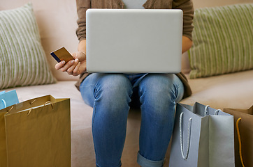 Image showing Person, credit card and laptop with shopping bags for online purchase or internet banking, ecommerce or payment. Hands, couch and fashion website for stress free order in home, discount or budget