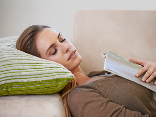 Image showing Woman, book and sofa sleeping for relax weekend in living room for wellness morning, holiday vacation or calm. Female person, magazine and comfortable in apartment home for casual, peace or resting