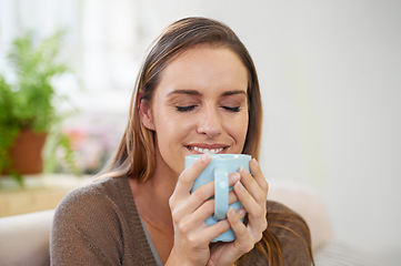 Image showing Coffee, happy and woman in home on sofa with drink, hot beverage and caffeine for breakfast. Morning, apartment and person with tea, mug and calm for relaxing, wellness and health in living room