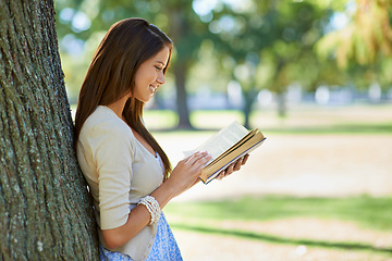 Image showing Happy woman, park and reading book for learning, education or leisure in summer. Young person with story, fiction or literature for language, knowledge and studying or creative inspiration in nature