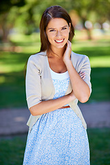 Image showing Happy woman, portrait and park for fashion in nature with travel, confidence and summer clothes. Young and casual person in floral dress with smile, style and arms crossed in a garden or outdoor