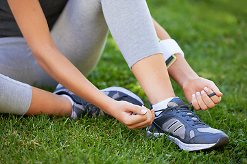 Image showing Shoes, hands and tie shoelace in park, ready for run or cardio for fitness and sports outdoor. Exercise, workout and person with sneakers on grass for training, health and wellness with runner