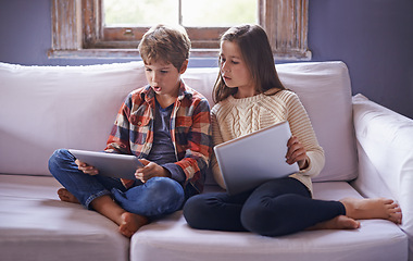 Image showing Boy, girl and tablet for gaming on couch together, technology and online streaming for bonding at home. Digital .world, internet with kids or sibling in living room, gamer app or elearning with ebook