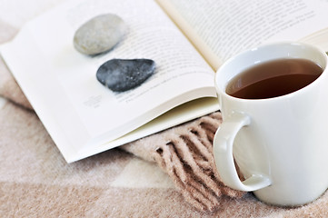 Image showing Relaxing reading with tea