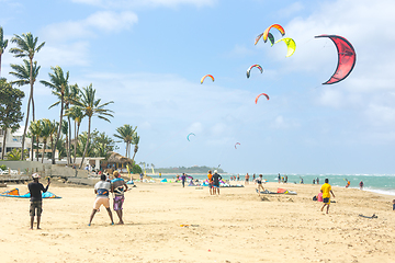 Image showing Crowd of active sporty people enjoying kitesurfing holidays and activities on perfect sunny day on Cabarete tropical sandy beach in Dominican Republic.