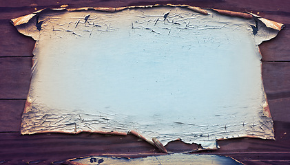 Image showing Old, parchment and paper on table with texture and detail of vintage material and above textile on desk. Wallpaper, peeling and ancient surface with damage from fire with holes with no people