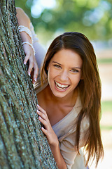 Image showing Woman, lean and tree with smile, portrait and happiness with joy and green fun for nature. Lady, laugh and sun with grass, forest and bokeh for exited playful summer with optimism and sunshine